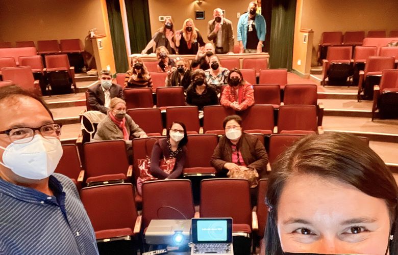Inspire Washington Executive Director Manny Cawaling (left) and Programs and Operations Manager Jessi Wasson (right) take a selfie with the attendees of their Cultural Futures meeting.