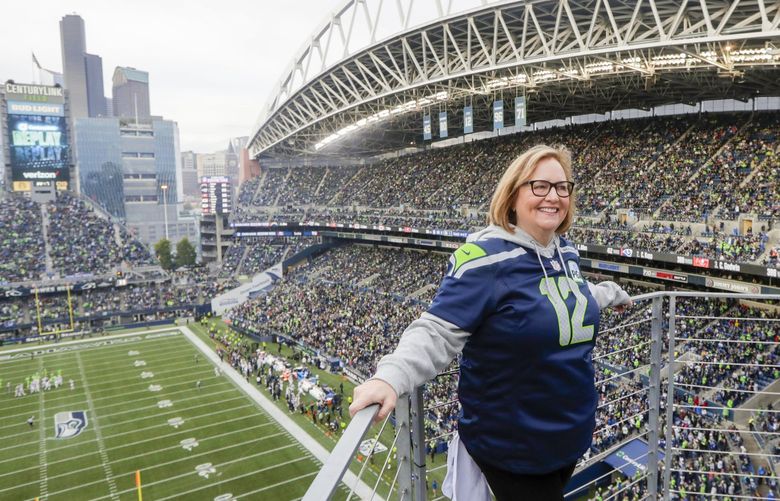 Seattle Seahawks owner Jody Allen stands on a balcony at CenturyLink Field after she raised the 12th man flag before the team’s NFL football game against the Los Angeles Rams, Thursday, Oct. 3, 2019, in Seattle. (AP Photo/Stephen Brashear) SE118