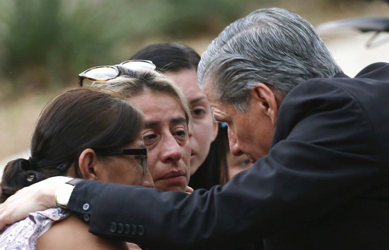 The Archbishop of San Antonio, Gustavo Garcia Seller, comforts families outside of the Civic Center following a deadly school shooting at Robb Elementary School in Uvalde, Texas Tuesday, May 24, 2022. (AP Photo/Dario Lopez-Mills) TXDL218 TXDL218