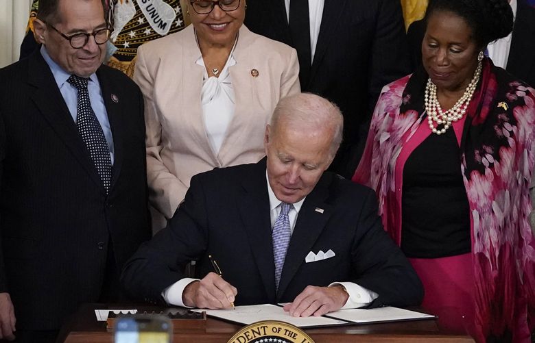 President Joe Biden signs an executive order in the East Room of the White House, Wednesday, May 25, 2022, in Washington. The order comes on the second anniversary of George Floyd’s death, and is focused on policing. (AP Photo/Alex Brandon) DCAB325 DCAB325