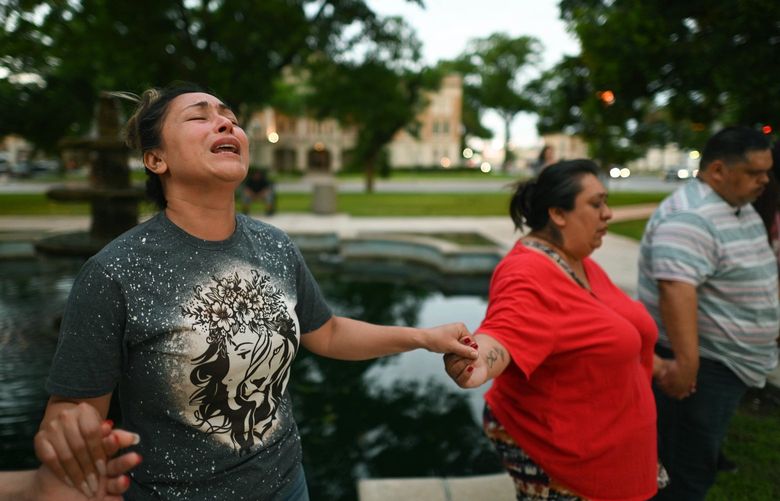Kladys Castellón prays during a vigil for the victims of a mass shooting at Robb Elementary School in Uvalde, Texas, on Tuesday, May 24, 2022. (Billy Calzada/The San Antonio Express-News via AP) TXSAE601 TXSAE601