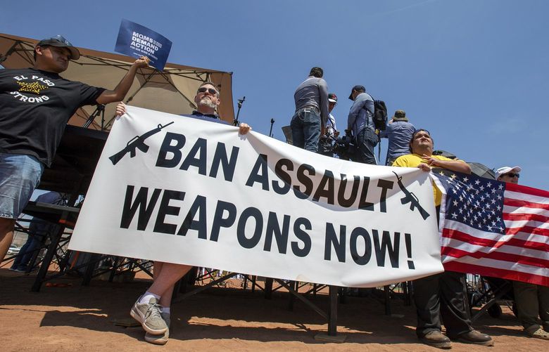 FILE – Demonstrators hold a banner to protest the visit of President Donald Trump to the border city after the Aug. 3 mass shooting in El Paso, Texas, on Aug. 7, 2019. A gunman killing multiple elementary school children and adults in Texas on Tuesday, May 24, 2022, adds to the state’s grim recent history of mass shootings. (AP Photo/Andres Leighton, File) CER802 CER802