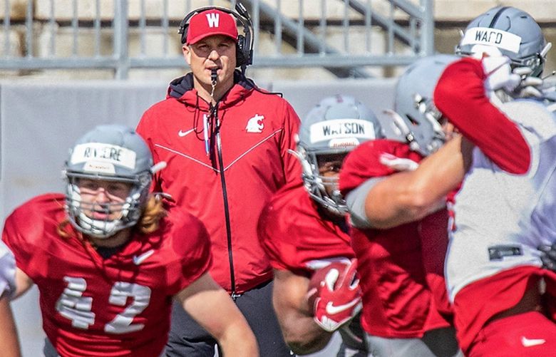 Washington State head coach Jake Dickert, top center, watches the team’s NCAA college football scrimmage Saturday, April 2, 2022, in Pullman, Wash. (August Frank/Lewiston Tribune via AP) IDLEW906 IDLEW906
