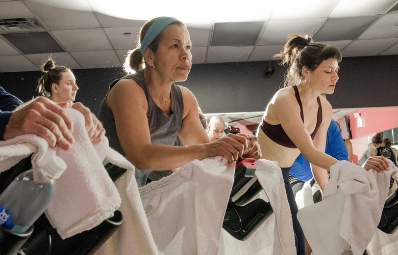 FILE â€” A spin class in the Brooklyn neighborhood of New York, April 24, 2018. A May 2022 study found exercisers expel a shocking number of tiny aerosol particles when they are working hard. (George Etheredge/The New York Times)