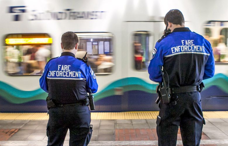 A Fare Enforcement Officers wait to board a southbound train at Chinatown station on Sound Transit’s Link Light Rail  Monday July 7, 2014.

139945  0429852885