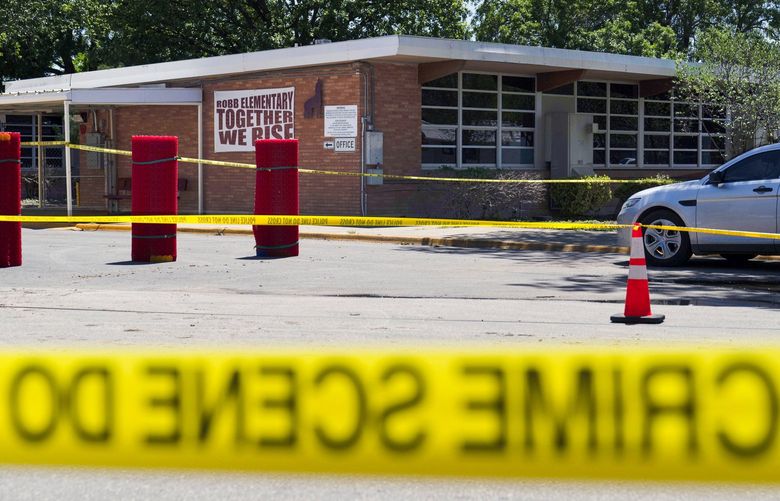 Crime scene tape surrounds Robb Elementary School in Uvalde, Texas, Wednesday, May 25, 2022. Desperation turned to heart-wrenching sorrow for families of grade schoolers killed after an 18-year-old gunman barricaded himself in their Texas classroom and began shooting, killing at least 19 fourth-graders and their two teachers. (AP Photo/Jae C. Hong) TXJH115