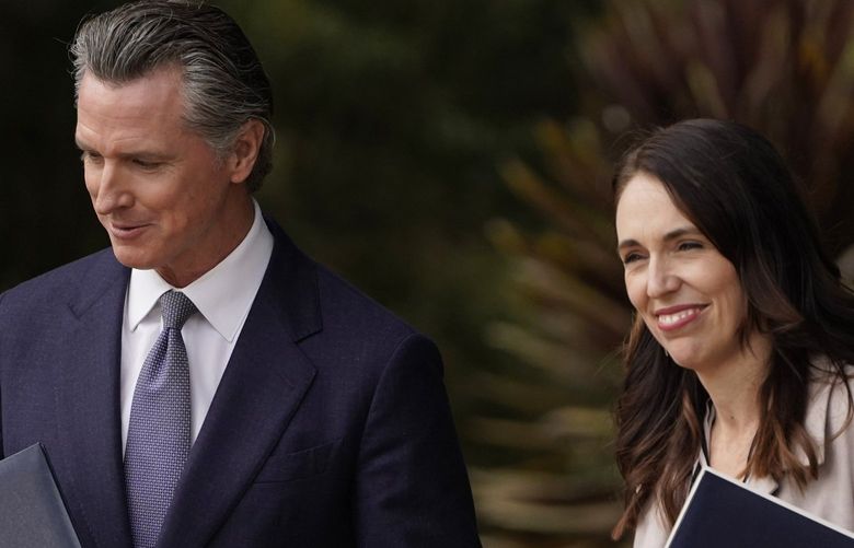 California Gov. Gavin Newsom and New Zealand Prime Minister Jacinda Ardern hold copies of agreements they made at the San Francisco Botanical Garden in San Francisco, Friday, May 27, 2022. Gov. Newsom met with New Zealand Prime Minister Jacinda Ardern in Golden Gate Park “to establish a new international partnership tackling climate change.” (AP Photo/Eric Risberg) EROTK EROTK