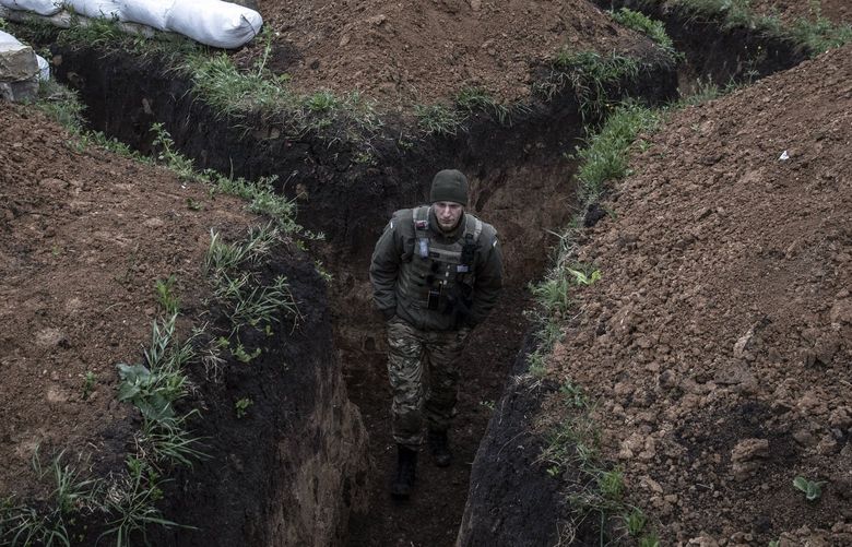A Ukrainian soldier on sentry duty in a trench system along the frontline near Izium in northeast Ukraine on Friday, May 27, 2022. (Finbarr O’Reilly/The New York Times) XNYT25 XNYT25