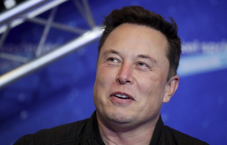 FILE – Tesla and SpaceX CEO Elon Musk arrives on the red carpet for the Axel Springer media award in Berlin on Dec. 1, 2020. (Hannibal Hanschke/Pool Photo via AP, File)