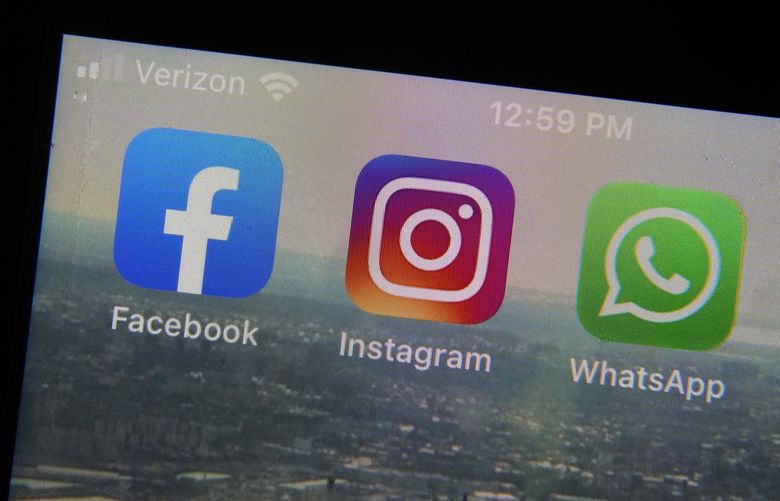 FILE – The mobile phone apps for, from left, Facebook, Instagram and WhatsApp are shown on a device in New York. The company that owns Facebook and Instagram said Monday, May 23, 2022, it will begin revealing more details about how advertisers target people with certain political ads, just months before the U.S. Midterm elections. (AP Photo/Richard Drew, File) NYSB129 NYSB129