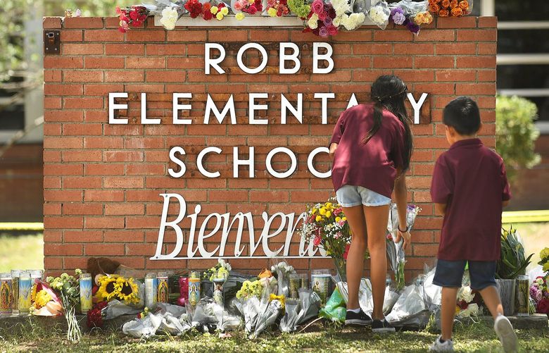 Family members who lost a sibling place flowers outside Robb Elementary School in Uvalde, Texas, on Wednesday, May 25, 2022. (Wally Skalij/Los Angeles Times/TNS) 48952911W 48952911W