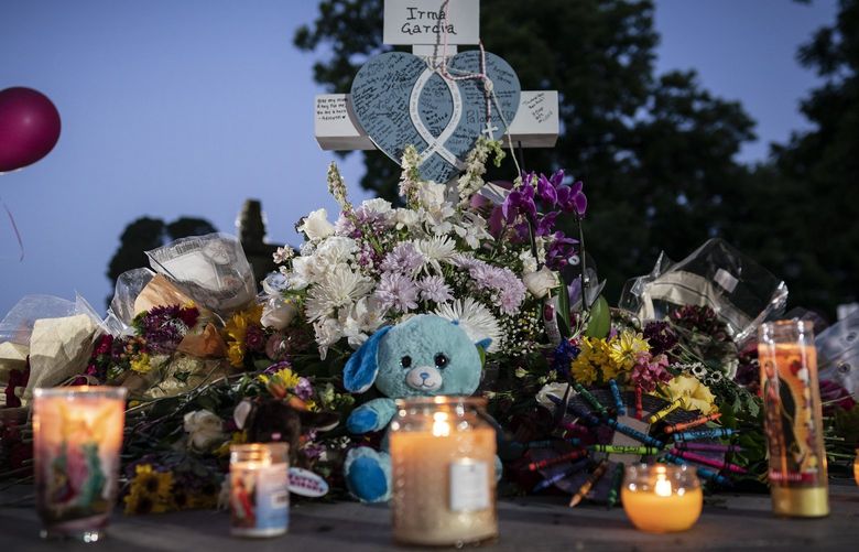 Balloons and candles adorn a memorial site in the town square for the victims killed in this week’s elementary school shooting early morning Friday, May 27, 2022, in Uvalde, Texas. (AP Photo/Wong Maye-E) NYWM102 NYWM102