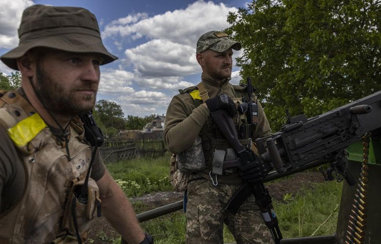 Pvt. Roman Verediuk, left, and Pvt. Ivan Ilkiv of the Territorial Defense Forces brigade guarding a checkpoint in the village of Vilne Pole, Ukraine, May 25, 2022. Only a few months ago, these soldiers were regular citizens, but this month they found themselves fighting on the eastern front lines of the war in Ukraine. (Ivor Prickett/The New York Times) XNYT179 XNYT179
