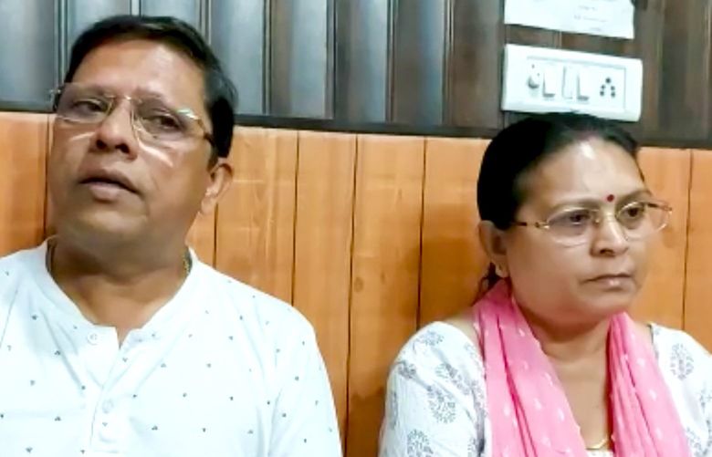 This image from video shows Sanjeev Ranjan Prasad, a 61-year-old retired government officer, and his wife Sadhana Prasad wait at a lawyer’s chamber in Haridwar, India, Thursday, May 12, 2022. The Indian couple has sued their pilot son and daughter-in-law in a court demanding a grandchild within a year or compensation of 50 million rupees ($675,675). Prasad said this was an emotional and sensitive issue for him and his wife and they cannot wait any longer. His son got married six years ago. (KK Productions via AP) HAR101