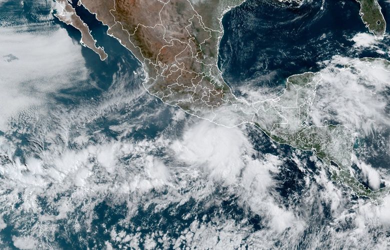 This satellite image made available by NOAA shows Hurricane Agatha, center, off the Pacific coast of Mexico on Sunday, May 29, 2022, at 11:20 a.m. EDT. (NOAA via AP) NY107 NY107