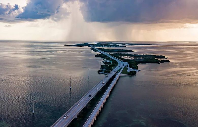 Cars make their way down the Overseas Highways Seven Mile Bridge near Little Duck Key and Bahia Honda State Park on Oct. 11, 2021. A person died in a parasailing accident near the bridge Monday, May 30, 2022. (Matias J. Ocner/Miami Herald/TNS) 49361186W 49361186W