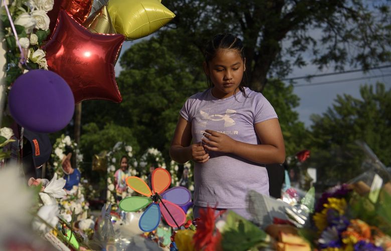 Aaliyah Banda, 11, visits a makeshift memorial following a mass shooting at Robb Elementary School, which left 19 children and two adults dead, in Uvalde, Texas on Tuesday,  May 31, 2022. It is the deadliest school shooting since the 2012 massacre in Newtown, Conn. (Callaghan O’Hare/The New York Times) XNYT65 XNYT65