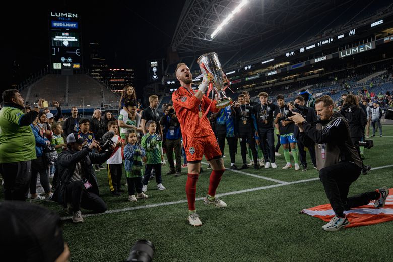 The Seattle Sounders FC goalkeeper Stefan Frei, the tournament’s most valuable player, raises the championship cup at Lumen Field in Seattle, May 4, 2022. Sounders captured Major League Soccer’s first CONCACAF Champions League title with a win over Pumas UNAM. (Jovelle Tamayo/The New York Times)