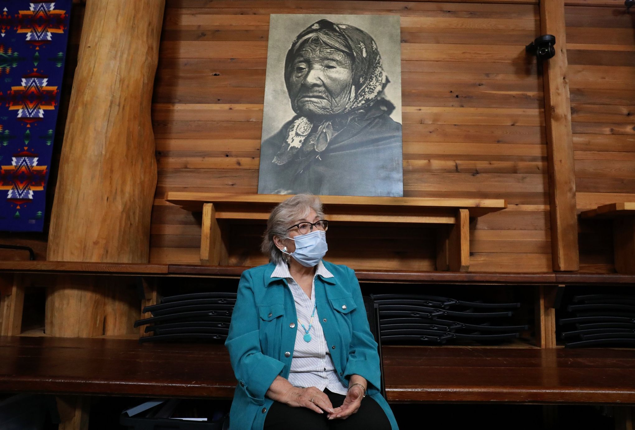 Cecile Hansen, chairwoman of the Duwamish tribal council, shown in their longhouse with a portrait of Princess Angeline, the eldest daughter of Chief Seattle.