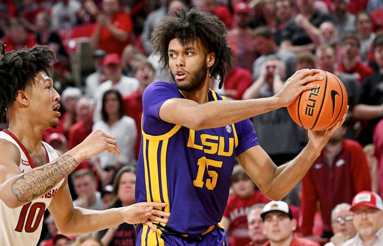 LSU center Efton Reid III (15) tries to get the ball past Arkansas forward Jaylin Williams (10) during the second half of an NCAA college basketball game Wednesday, March 2, 2022, in Fayetteville, Ark. (AP Photo/Michael Woods)