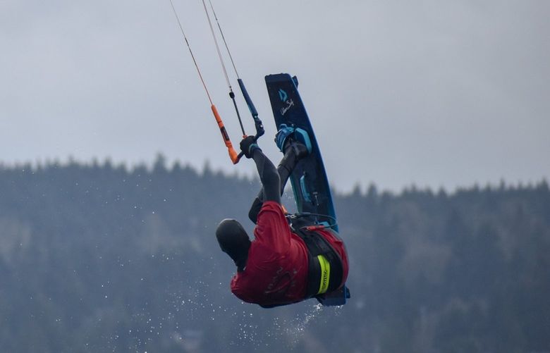 Experienced Seattle-area kiteboarder Tom Dawson executes aerial maneuvers while kiteboarding.