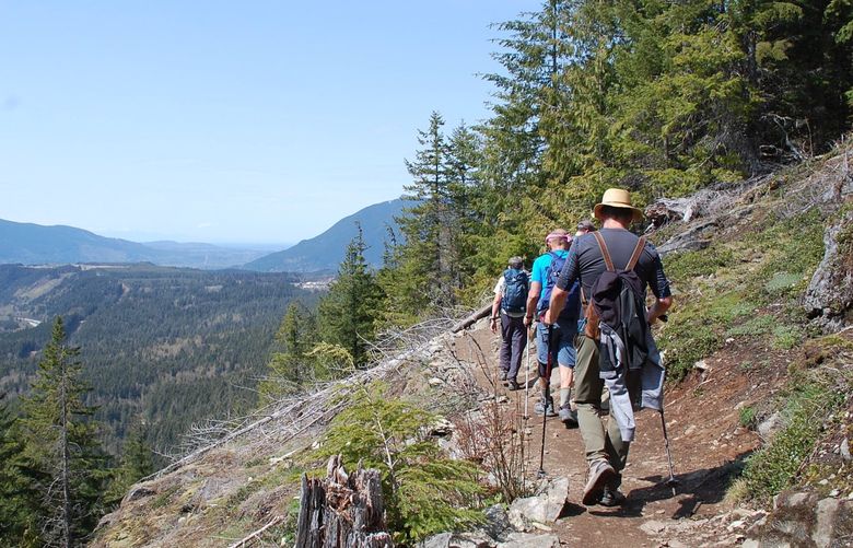 Hikers from the OutVentures outdoors group ascend the 4.4-mile round-trip trail to Dirty Harry’s Balcony in the Cascade foothills off Interstate 90.