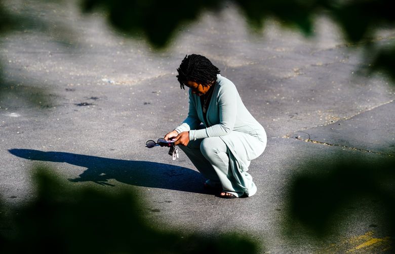 A person pauses outside the scene of a shooting at a supermarket, in Buffalo, N.Y., Sunday, May 15, 2022. (AP Photo/Matt Rourke) NYMR116 NYMR116