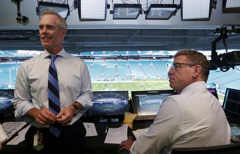 FILE – Fox Sports play-by-play announcer Joe Buck, left, and analyst Troy Aikman work in the broadcast booth before a preseason NFL football game between the Miami Dolphins and Jacksonville Jaguars in Miami Gardens, Fla., Aug. 22, 2019. Aikman is on the verge of leaving Fox after 22 years to become the lead analyst on ESPN’s Monday Night Football. The New York Post reported that Aikman will sign a five-year deal that would rival the $17.5 million per year Tony Romo is making at CBS. (AP Photo/Lynne Sladky, File)
