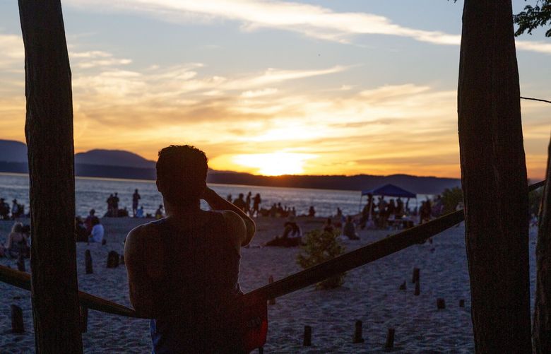 GOLDEN GARDENS PARK – LO-LINES ONLY_ SUMMER SOLSTICE- 061921
People relax along the beach at Golden Gardens Park on Sunday, June 20, 2021 in Seattle. Sunday marks the longest day of the year and the first “official” day of summer.