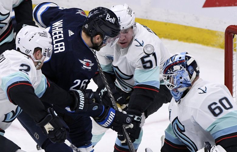Seattle Kraken goaltender Chris Driedger (60) makes a save against Winnipeg Jets’ Blake Wheeler (26) during the second period of NHL hockey game action in Winnipeg, Manitoba, Sunday, May 1, 2022. (Fred Greenslade/The Canadian Press via AP) FCG106 FCG106