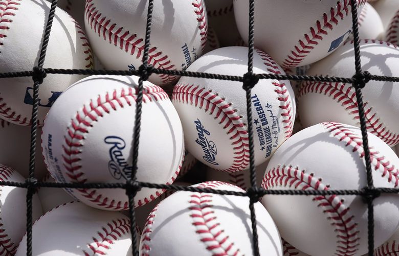 Seattle Mariners’ practice balls are shown before an opening day baseball game against the Chicago White Sox in Chicago, Tuesday, April 12, 2022. (AP Photo/Nam Y. Huh)
