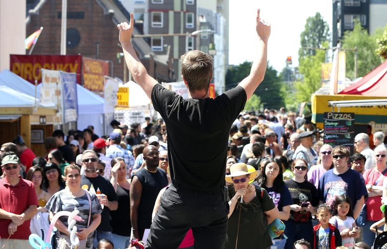 Jules the Juggler (AKA Jules McEvoy) entertained a crowd at the 50th annual University Street Fair. The fair continues Sunday along University Way NE 210319
