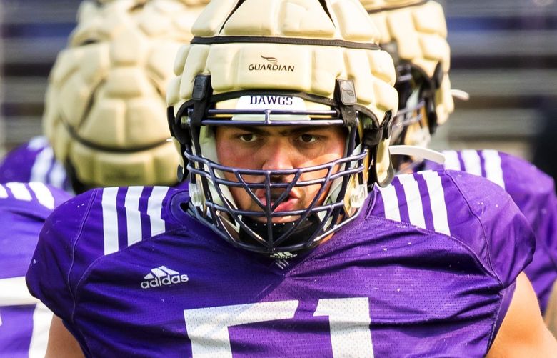 Offensive lineman Jaxson Kirkland gets in position as the University of Washington Huskies practice during fall camp at Husky Stadium in Seattle Saturday August 14, 2021. 217935