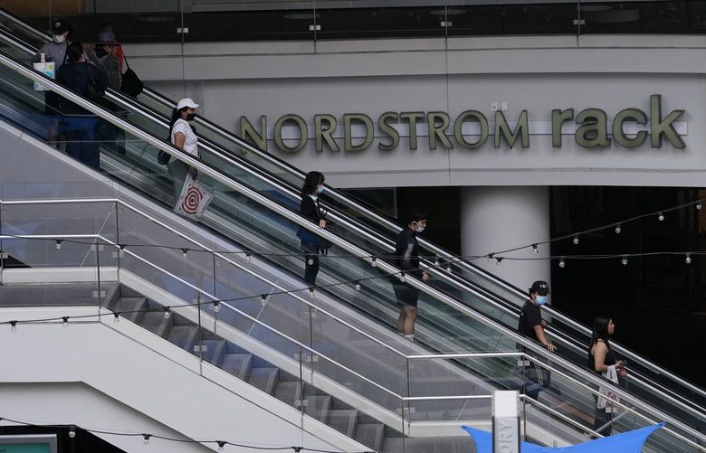 People wear face masks as they shop at the Nordstrom Local DTLA downtown Los Angeles on Tuesday, March 15, 2022.  (AP Photo/Damian Dovarganes)