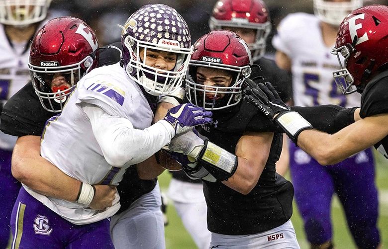Lake Stevens High School Jayden Limar (17) is tackled at the WIAA 4A state semifinal football game between Lake Stevens and Eastlake at Pop Keeney Stadium in Bothell on Saturday, Nov. 27, 2021.