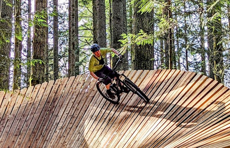 Peter Giese gives a banked turn boardwalk a whirl on the Semper Dirticus trail at Duthie Hill Ride Park.