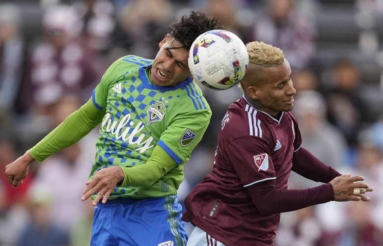 Seattle Sounders defender Xavier Arreaga, left, and Colorado Rapids forward Michael Barrios collide in air while trying to head the ball in the first half of an MLS soccer match Sunday, May 22, 2022, in Commerce City, Colo. (AP Photo/David Zalubowski) CODZ134 CODZ134