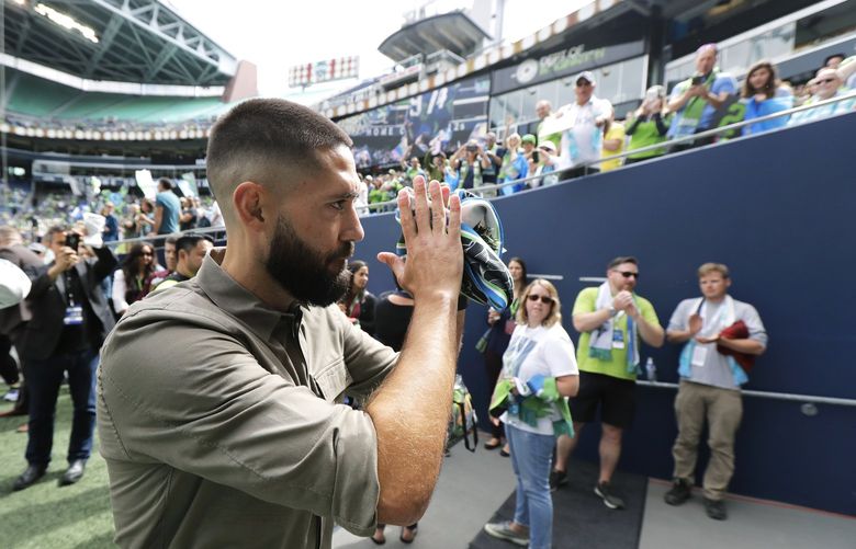 FILE – Seattle Sounders forward Clint Dempsey applauds supporters as he walks off the field, Saturday, Sept. 1, 2018, in Seattle, following a pre-match ceremony in his honor after he announced his retirement from professional soccer. Four years removed from playing, Dempsey is set to be inducted into the U.S. National Soccer Hall of Fame on Saturday, May 21, 2022. (AP Photo/Ted S. Warren, File) NYAB502 NYAB502