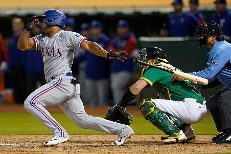 Rangers rally in 9th again to beat A's 8-5 for 3rd in row