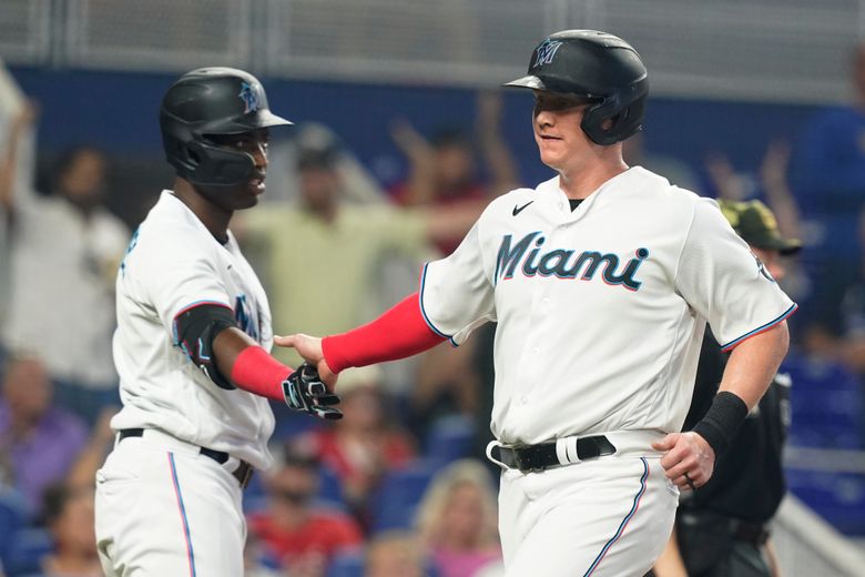 Miami Marlins' Jesus Sanchez, left, is congratulated by first base