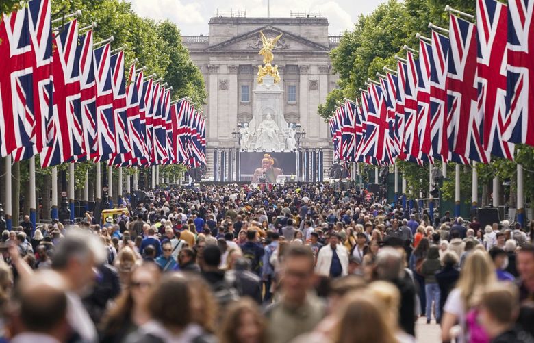 People walk along The Mall in London, Wednesday, June 1, 2022, ahead of the start of the Queen’s Jubilee weekend. Britain will celebrate Queen Elizabeth II’s 70 years on the throne with four days of festivities beginning with her ceremonial birthday parade on June 2, 2022. The 96-year-old monarch’s Platinum Jubilee will kick off with a full staging of Trooping the Color, the parade of more than 1,400 soldiers that marks the queen’s official birthday. (AP Photo/Alberto Pezzali) XAP116 XAP116