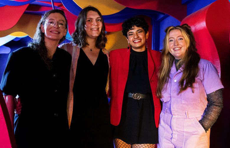 From left: Hannah Balducci, Eve Matson, Varsha Nandula, and Siobhan Fox, co-founders of “Sapphic Seattle,” a community group for queer women, pose for a portrait at Supernova Seattle club’s “lava lounge,” Tuesday, May 31, 2022 in Sodo. “Sapphic Seattle” organizes parties at Supernova Seattle club.