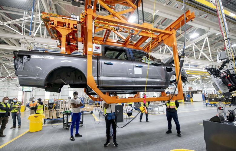 Ford employees assemble the Ford F-150 Lightning at the Ford Rouge Electric Vehicle Center, in Dearborn, Michigan, on March 2, 2022. The fully electric truck is expected to go on sale to the general public in the spring. (David Guralnick/The Detroit News/TNS) 49521259W 49521259W