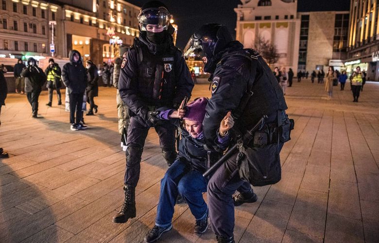 FILE â€” Russian police officers arrest an anti-war protester in central Moscow, on Feb. 25, 2022. Three months ago, President Vladimir Putin signed a law designed to silence war against Ukraine criticizers; now, at least 50 people face years-long prison. (Sergey Ponomarev/The New York Times) XNYT103