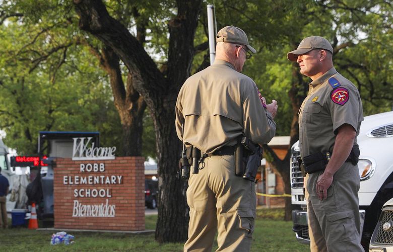 Officials continue investigations at Robb Elementary School in Uvalde, Texas, Wednesday, May 25, 2022. On Tuesday, 18-year-old Salvador Ramos entered the school and killed multiple people including students. (Jerry Lara/The San Antonio Express-News via AP) TXSAE604