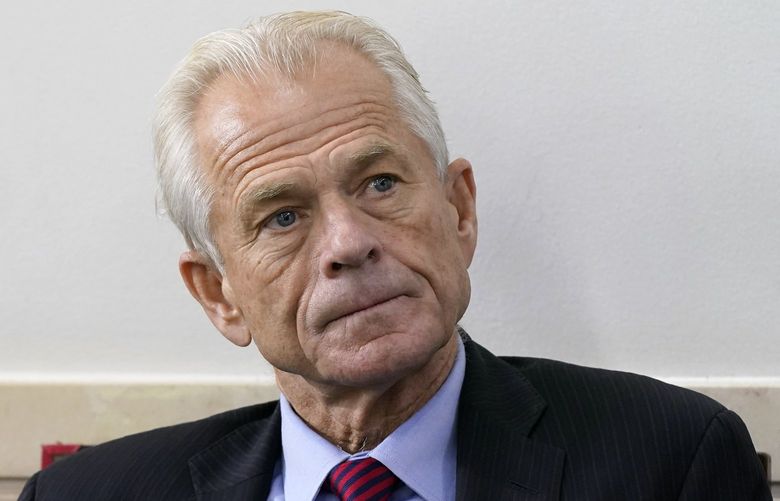 FILE – White House trade adviser Peter Navarro listens as President Donald Trump speaks during a news conference at the White House, on Aug. 14, 2020, in Washington. Former Trump adviser Navarro revealed in a draft court filing Tuesday, May 31, 2022, that he has been subpoenaed to appear before a grand jury this week as part of the Justice Department’s sprawling probe into the deadly insurrection at the U.S. Capitol. (AP Photo/Patrick Semansky, File) WX102 WX102