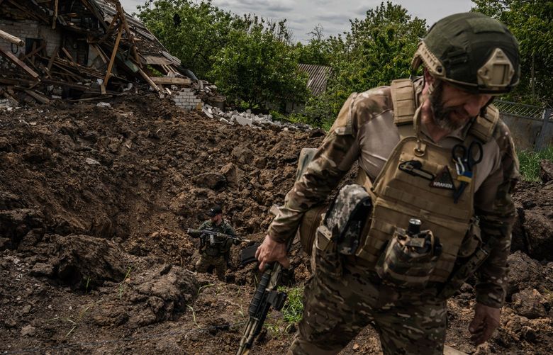 Kraken Regiment members Oleg Sapachenko and Andrii Maleev in Ruska Lozova, on May 30. MUST CREDIT: Photo for The Washington Post by Wojciech Grzedzinski.