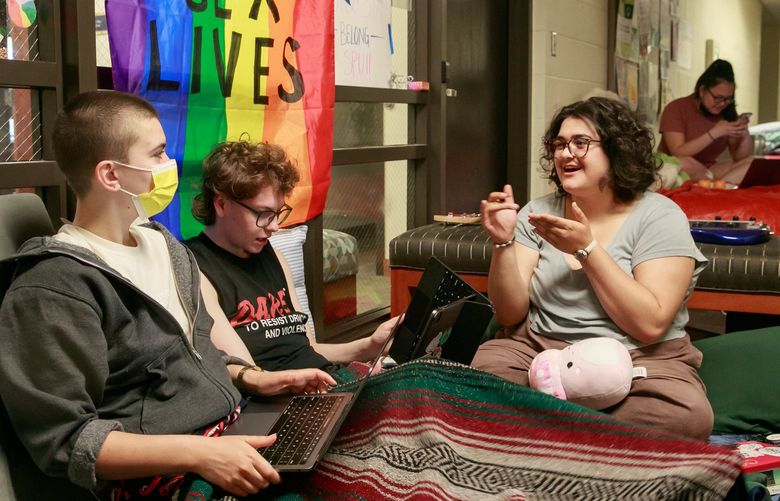 Seattle Pacific University students Grace Ihle CQ, from left, Bennett Bennett CQ and Sierra Lebovitz CQ participate in an ongoing sit-in inside the university’s administrative building, Demaray Hall, Friday, June 3, 2022. “This is the most community that I’ve felt at Seattle Pacific UniversityÉ nothing has felt this safe and loving,” says Bennett. “I’m a Christian. I’m a queer Christian and I feel god’s presence so distinctly here.” 220602