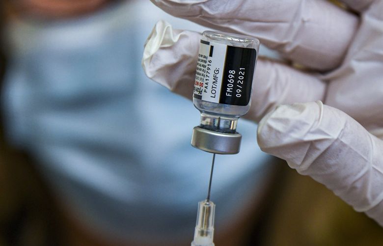 A pharmacist prepares a COVID-19 booster shot in the vaccination clinic at Meritus Medical Center in Hagerstown, Md., Feb. 22, 2022. Health experts, including the Centers for Disease Control and Prevention, recommend that pregnant women get vaccinated against the coronavirus as soon as possible, to protect both maternal and fetal health. (Kenny Holston/The New York Times) XNYT93 XNYT93