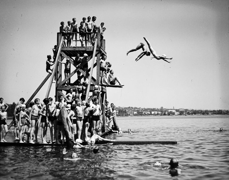 No way such a diving board would exist today. But it did when this photo was taken June 25, 1936, at Green Lake. At 16 feet, the board’s high platform is 4 feet higher than what is now allowed in Seattle parks. And all those kids crowded at the top? No, no. Only one diver at a time, please. (Seattle Municipal Archives)